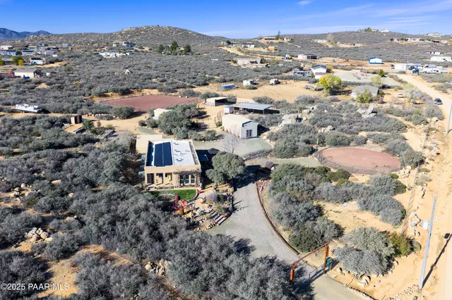 a view of a balcony with chairs and a potted plant