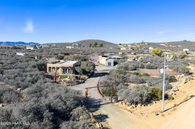 a view of a chairs and table in a backyard