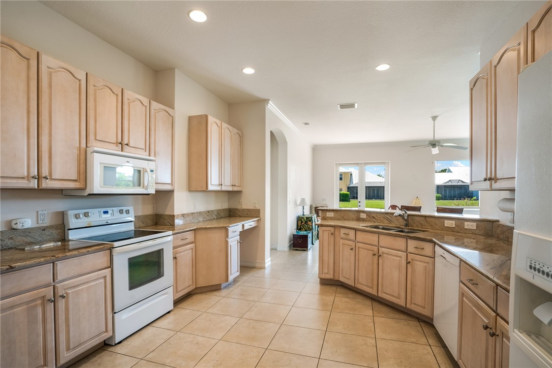 4565 Bridgepointe Way, Unit 142 Vero Beach, FL 32967 - Photo 13 of 36 a kitchen with a sink stove top oven and cabinets
