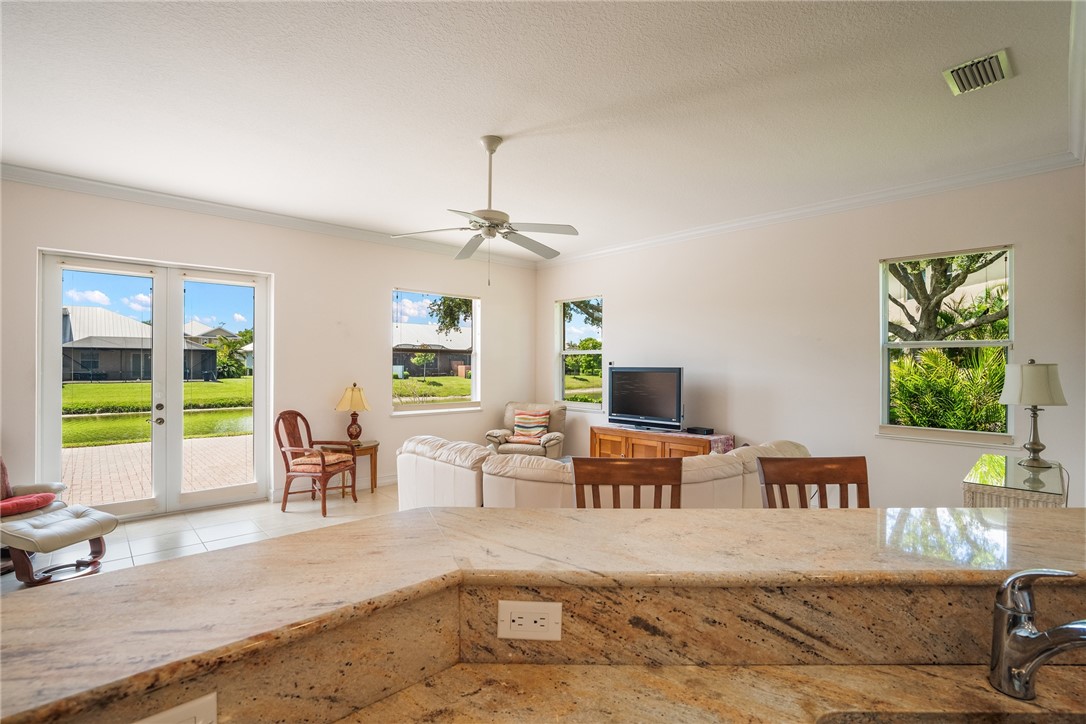 4565 Bridgepointe Way, Unit 142 Vero Beach, FL 32967 - Photo 16 of 36 a living room with furniture and a flat screen tv