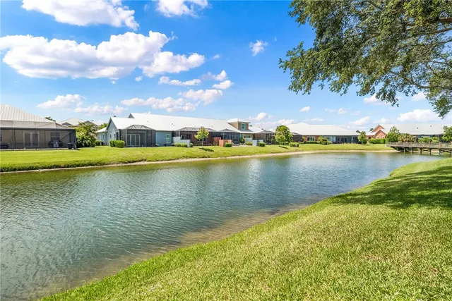 a view of a lake with houses in the back