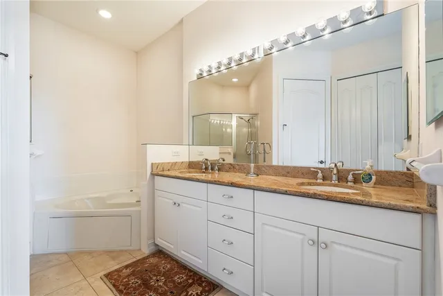 a bathroom with a double vanity sink and mirror