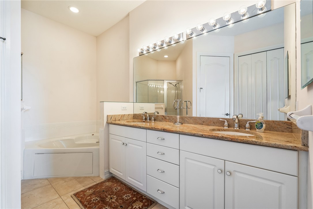 4565 Bridgepointe Way, Unit 142 Vero Beach, FL 32967 - Photo 21 of 36 a bathroom with a double vanity sink and mirror