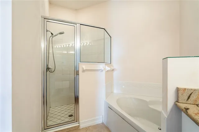 a bathroom with a bathtub and a shower