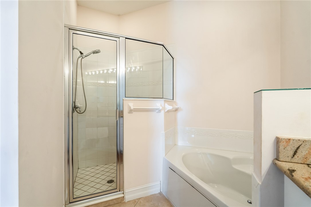 4565 Bridgepointe Way, Unit 142 Vero Beach, FL 32967 - Photo 22 of 36 a bathroom with a bathtub and a shower