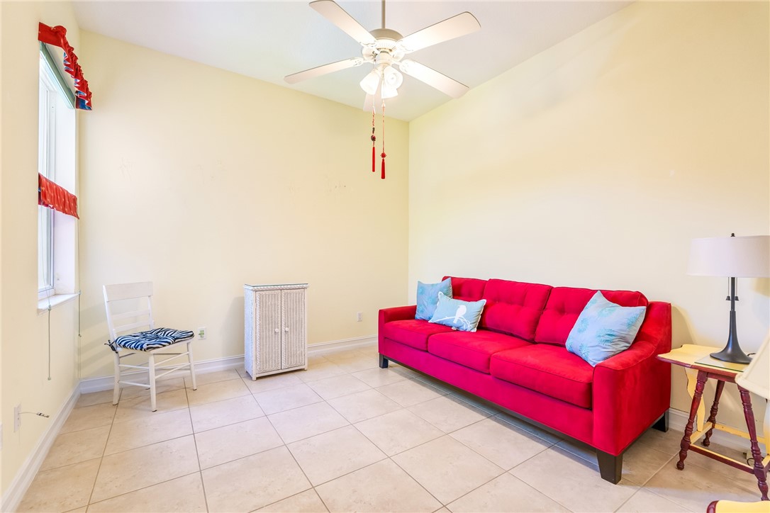 4565 Bridgepointe Way, Unit 142 Vero Beach, FL 32967 - Photo 24 of 36 a living room with furniture and a rug