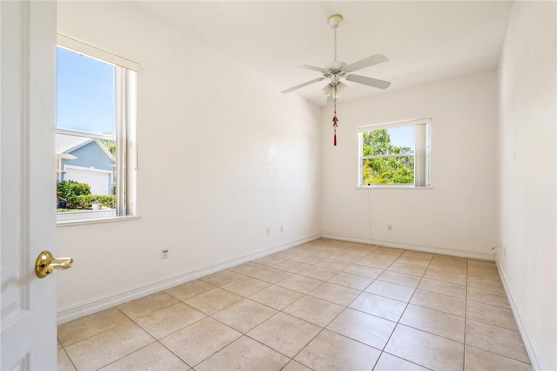 4565 Bridgepointe Way, Unit 142 Vero Beach, FL 32967 - Photo 27 of 36 an empty room with windows and fan