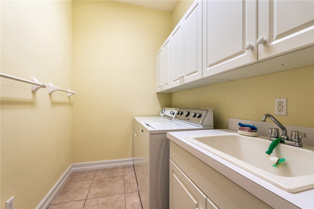 4565 Bridgepointe Way, Unit 142 Vero Beach, FL 32967 - Photo 28 of 36 a utility room with dryer and washer