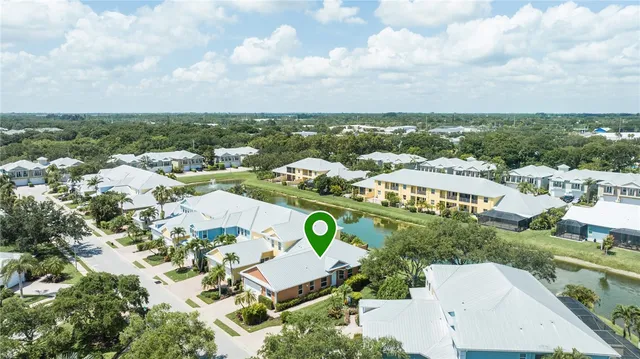 an aerial view of multiple houses with yard