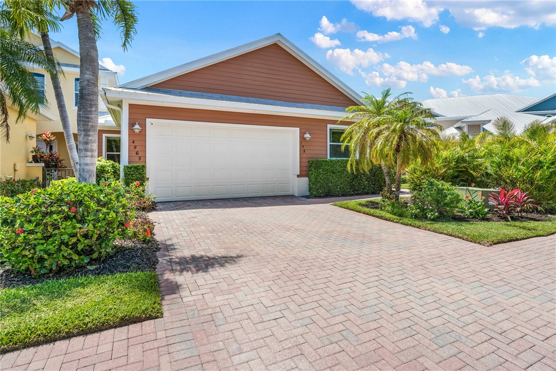 4565 Bridgepointe Way, Unit 142 Vero Beach, FL 32967 - Photo 3 of 36 a front view of a house with garden