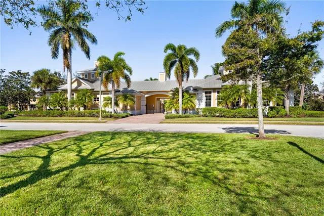 a front view of multi story residential apartment building with yard and green space