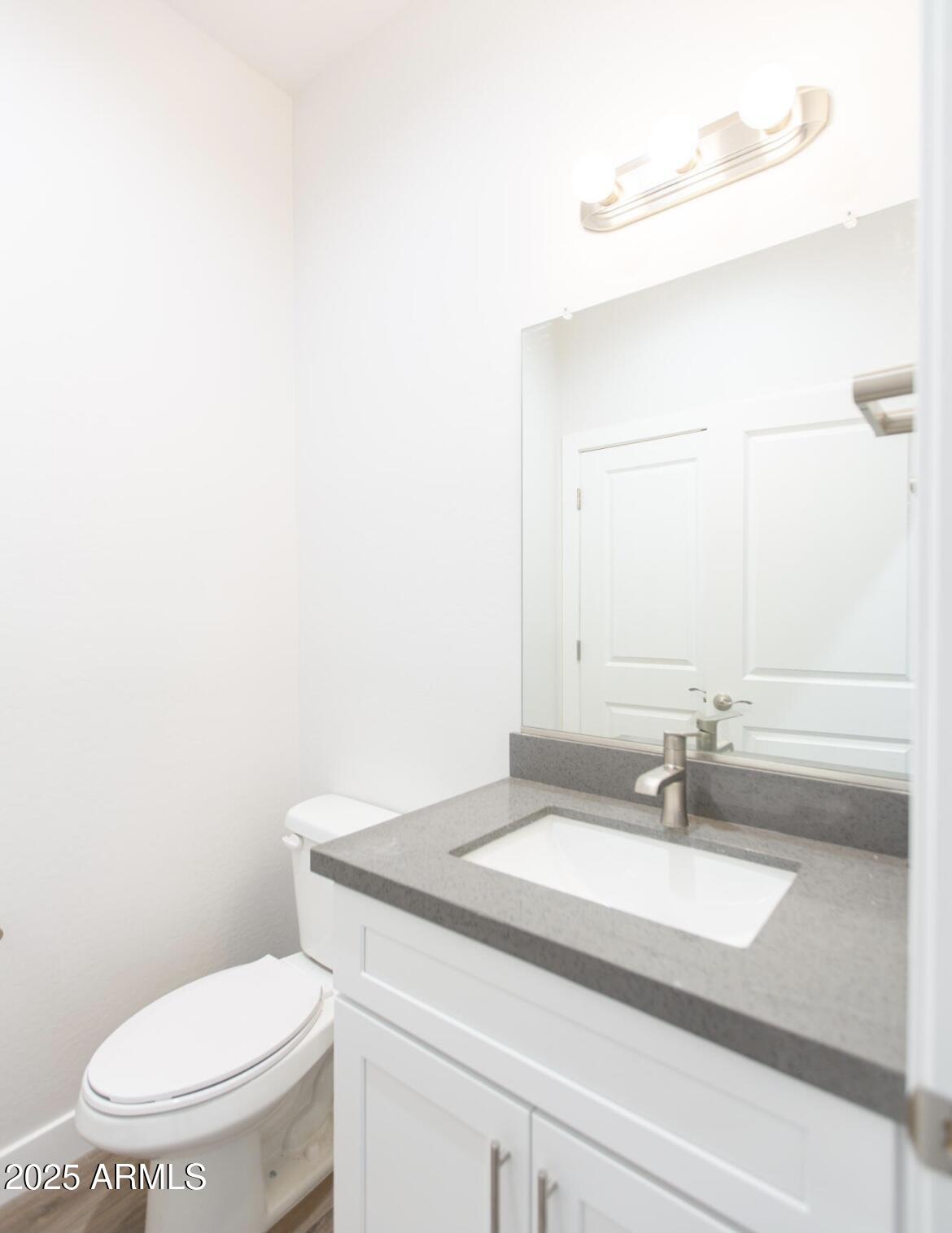 1850 North 51st Street, Unit 5 Phoenix, AZ 85008 - Photo 7 of 23 a bathroom with a sink a toilet and mirror