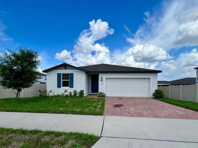 a front view of a house with a yard and a garage