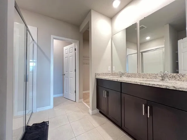 a view of kitchen with stainless steel appliances granite countertop a sink and cabinets