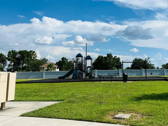a view of a garden with a building in the background