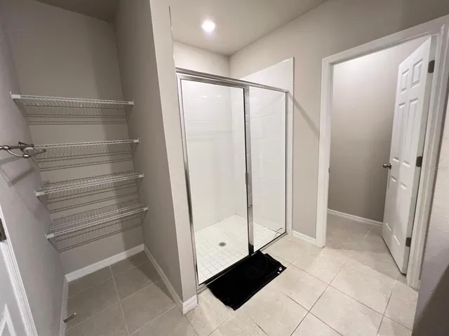 a view of an empty room with a chandeliers