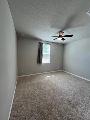 a large kitchen with a large counter top stainless steel appliances and cabinets