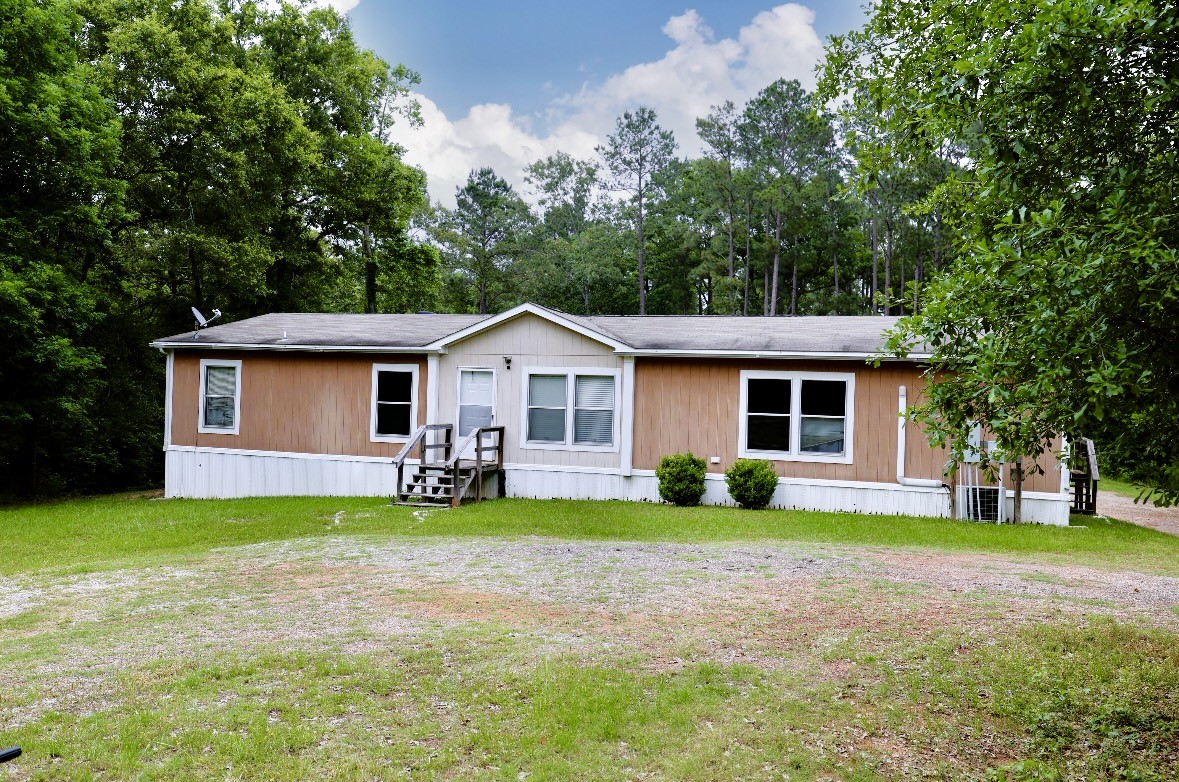 a front view of house with yard and green space