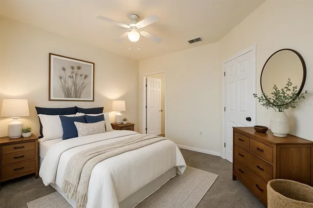 a bedroom with bed and a chandelier