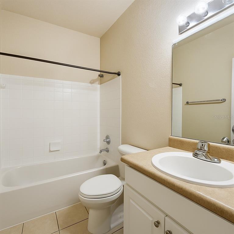 4877 Northwest 42nd Road, Unit 106 Gainesville, FL 32606 - Photo 17 of 27 a bathroom with a sink a toilet and shower