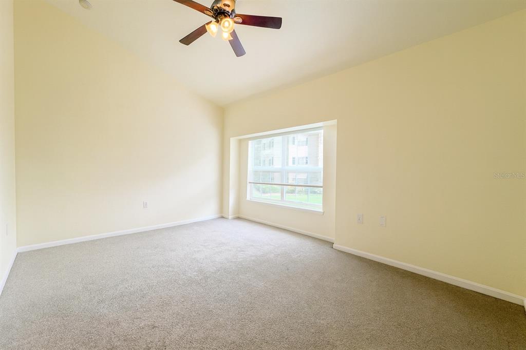 4877 Northwest 42nd Road, Unit 106 Gainesville, FL 32606 - Photo 18 of 27 an empty room with a window and a fan