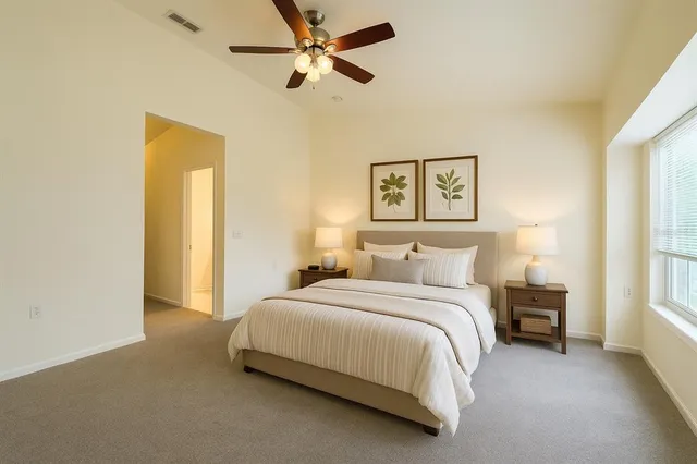 a bedroom with a bed and a painting on the wall