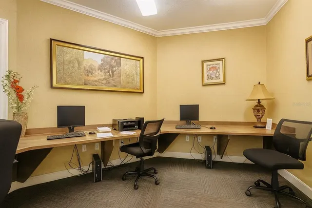 a view of a workspace with furniture and a workspace