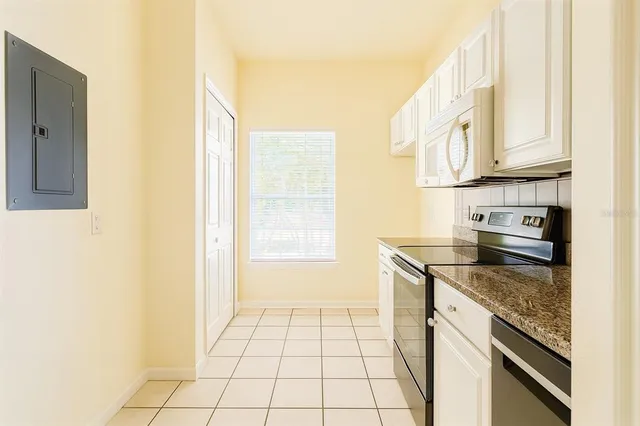 a kitchen with a sink a stove and cabinets