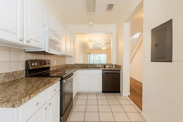 a kitchen with a sink a stove and cabinets