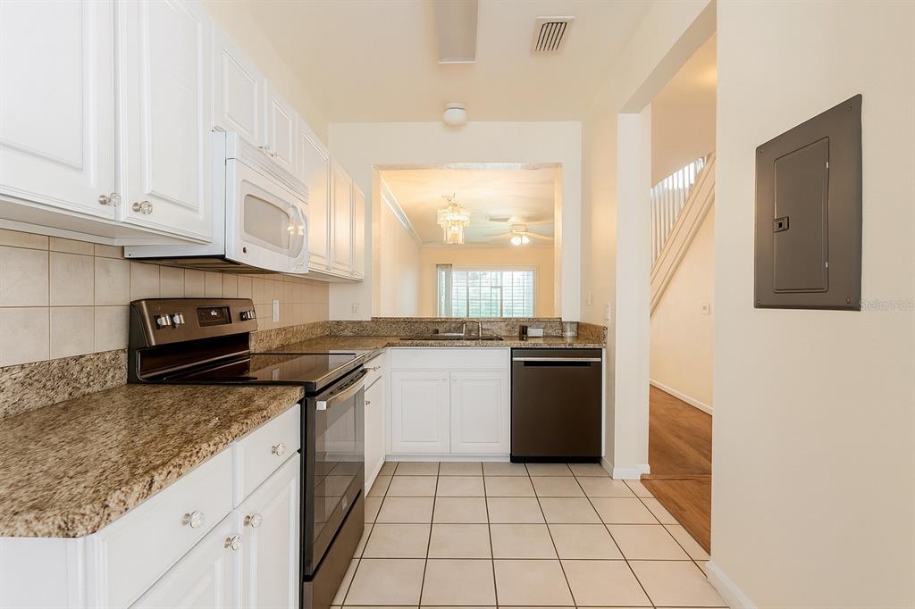 4877 Northwest 42nd Road, Unit 106 Gainesville, FL 32606 - Photo 4 of 27 a kitchen with a sink a stove and cabinets