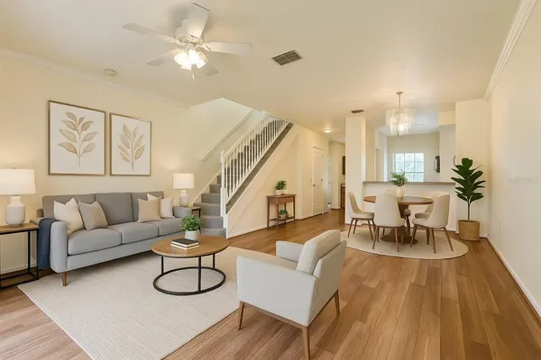 a living room with furniture and wooden floor