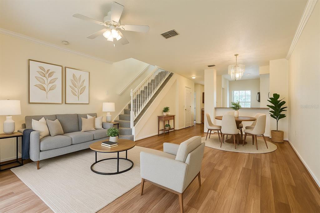 4877 Northwest 42nd Road, Unit 106 Gainesville, FL 32606 - Photo 9 of 27 a living room with furniture and wooden floor