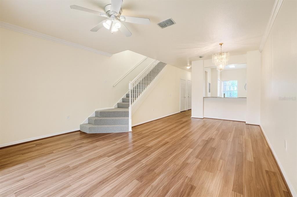 4877 Northwest 42nd Road, Unit 106 Gainesville, FL 32606 - Photo 10 of 27 wooden floor in an empty room with a window