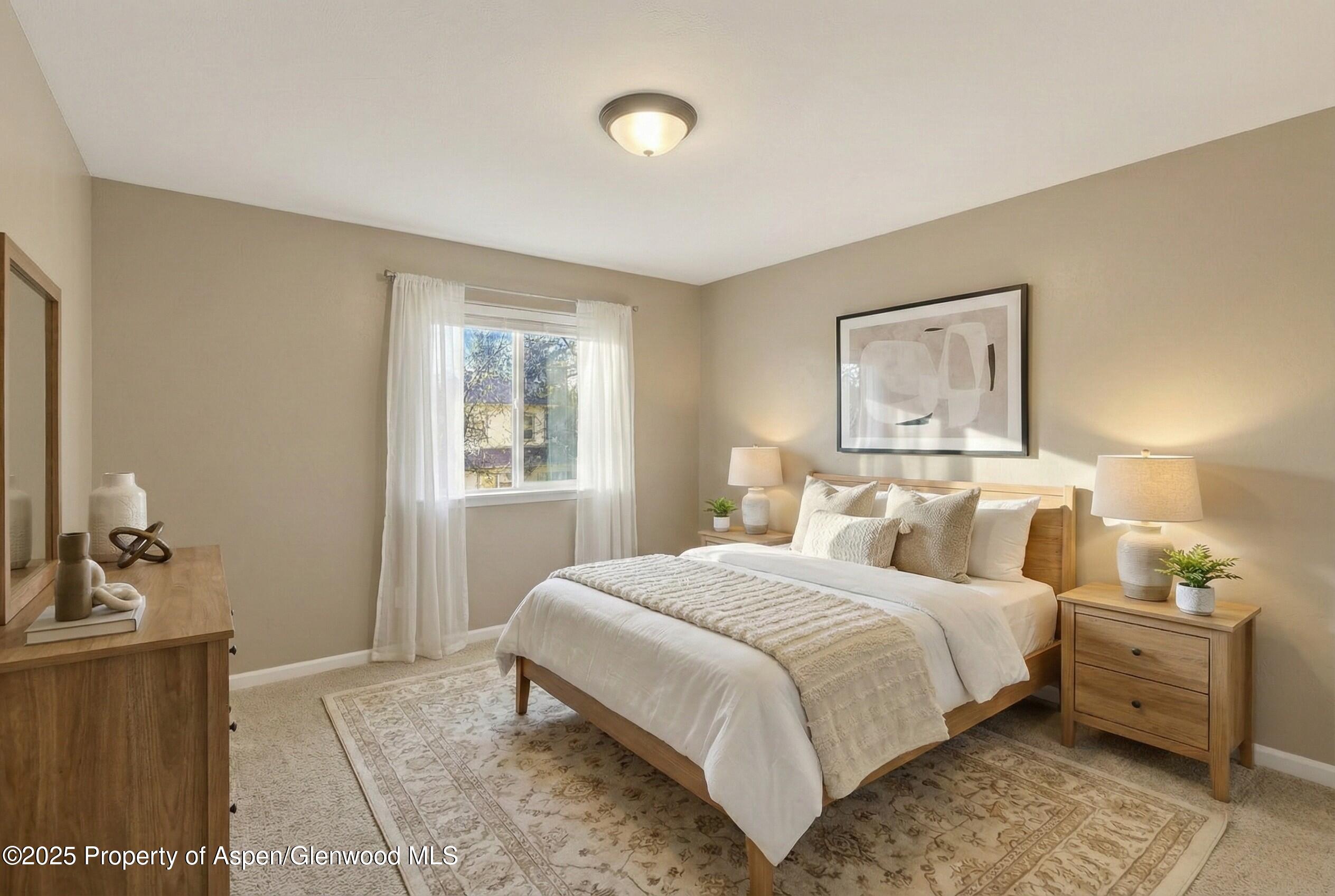 830 Donegan Road, Unit D Glenwood Springs, CO 81601 - Photo 11 of 21 a bedroom with a bed and wooden floor