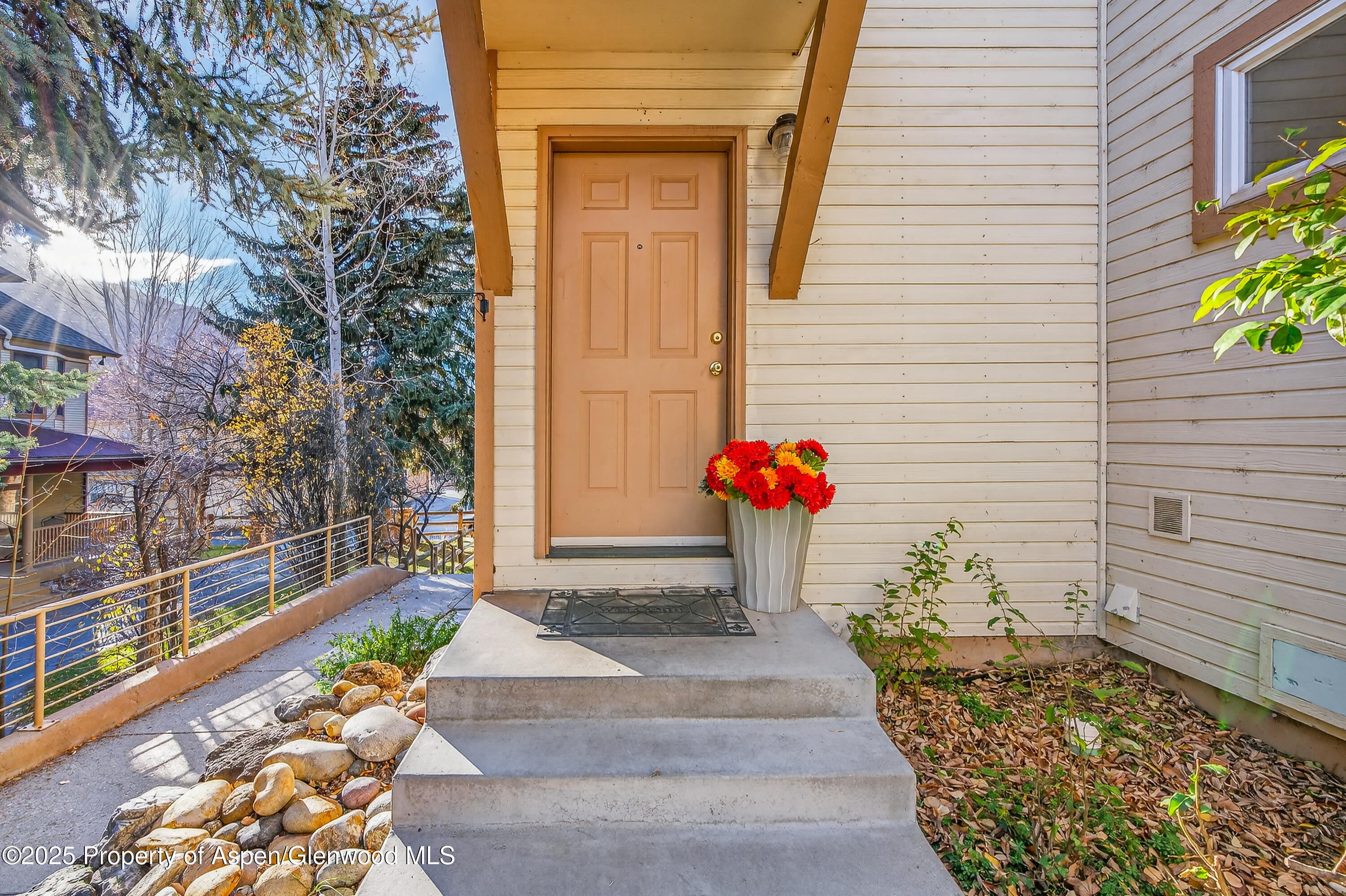 830 Donegan Road, Unit D Glenwood Springs, CO 81601 - Photo 16 of 21 a front view of a house with a garden