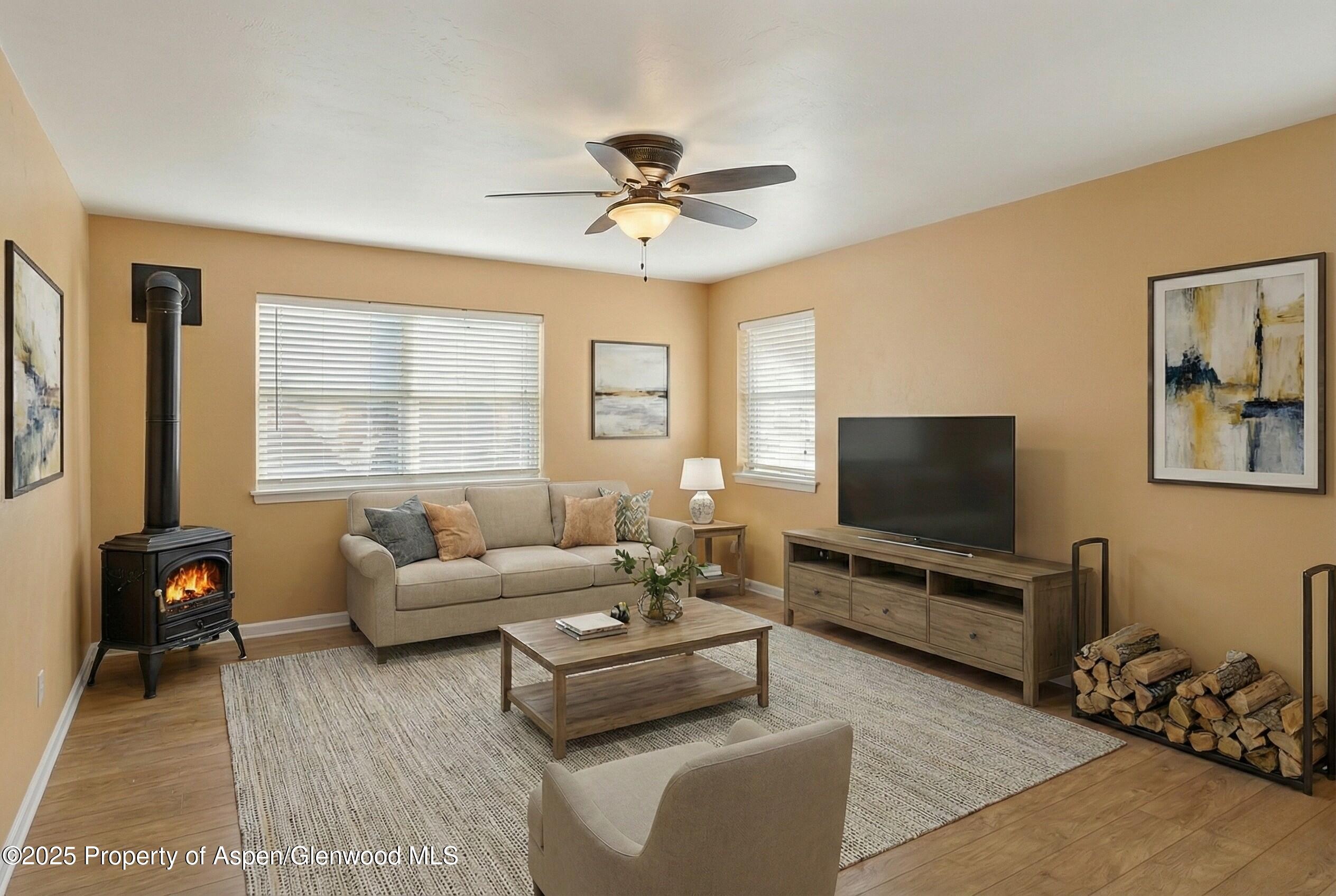 830 Donegan Road, Unit D Glenwood Springs, CO 81601 - Photo 2 of 21 a living room with furniture and a flat screen tv