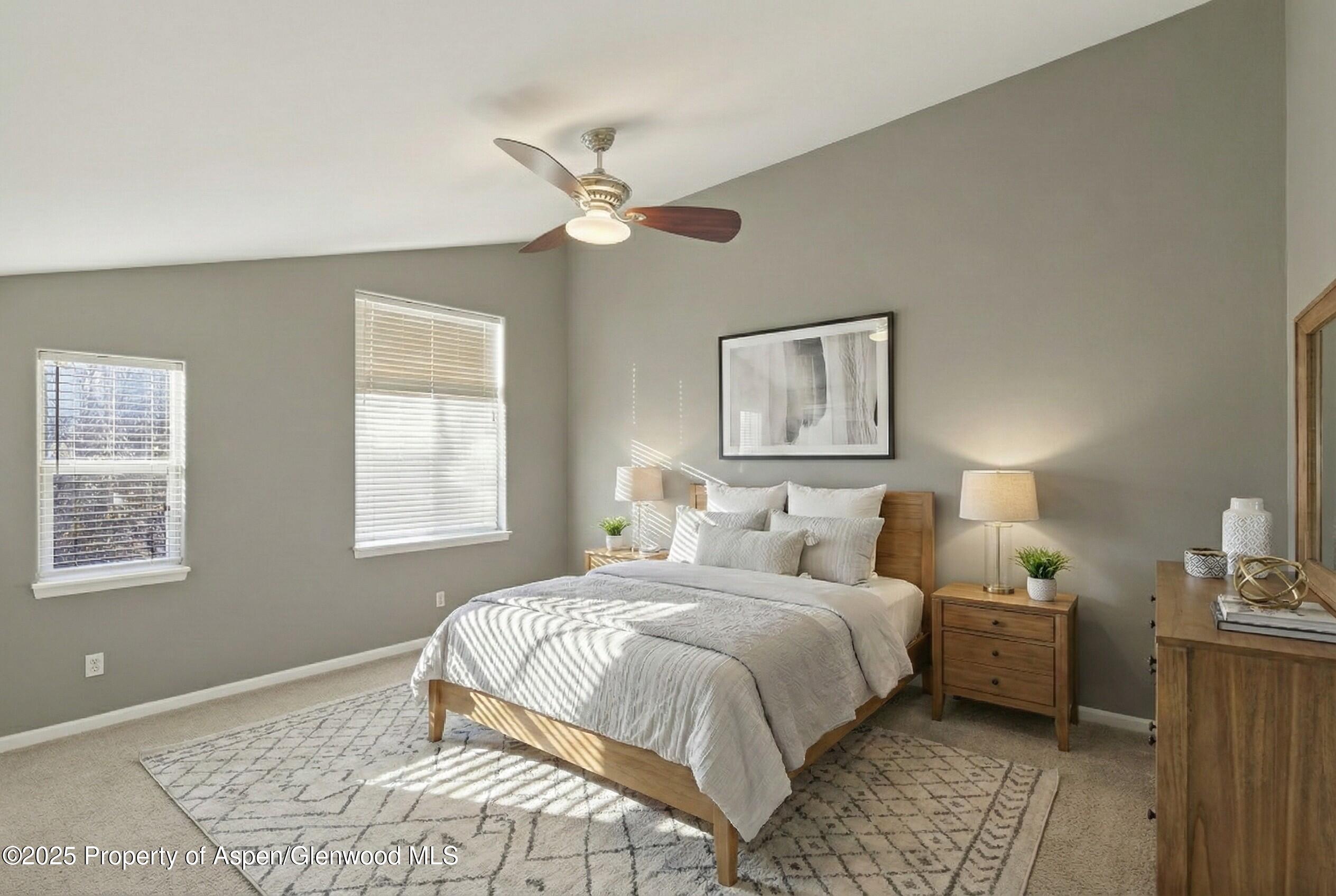 830 Donegan Road, Unit D Glenwood Springs, CO 81601 - Photo 7 of 21 a bedroom with a bed lamp and a window