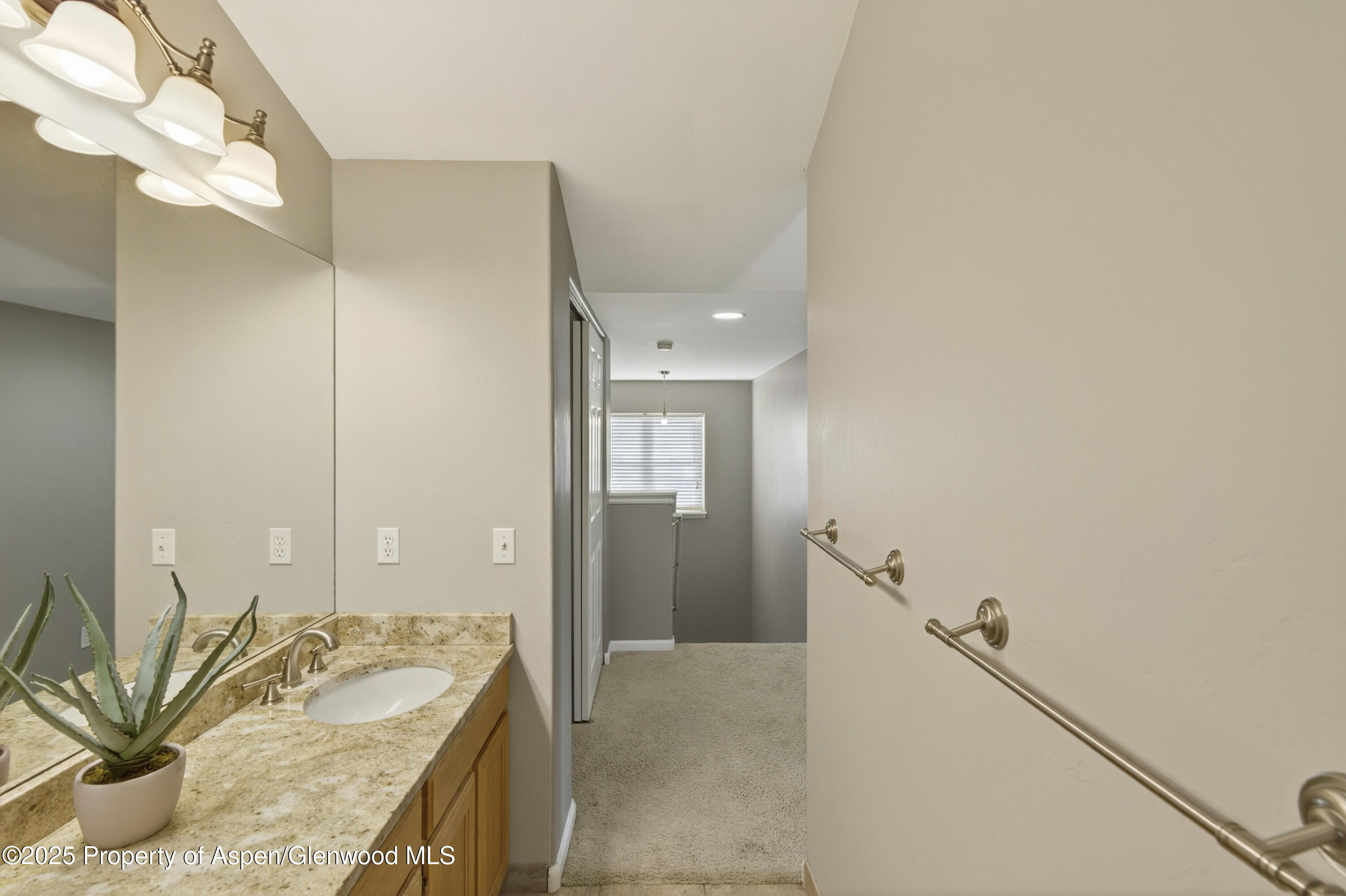 830 Donegan Road, Unit D Glenwood Springs, CO 81601 - Photo 10 of 21 a bathroom with a granite countertop sink and a mirror