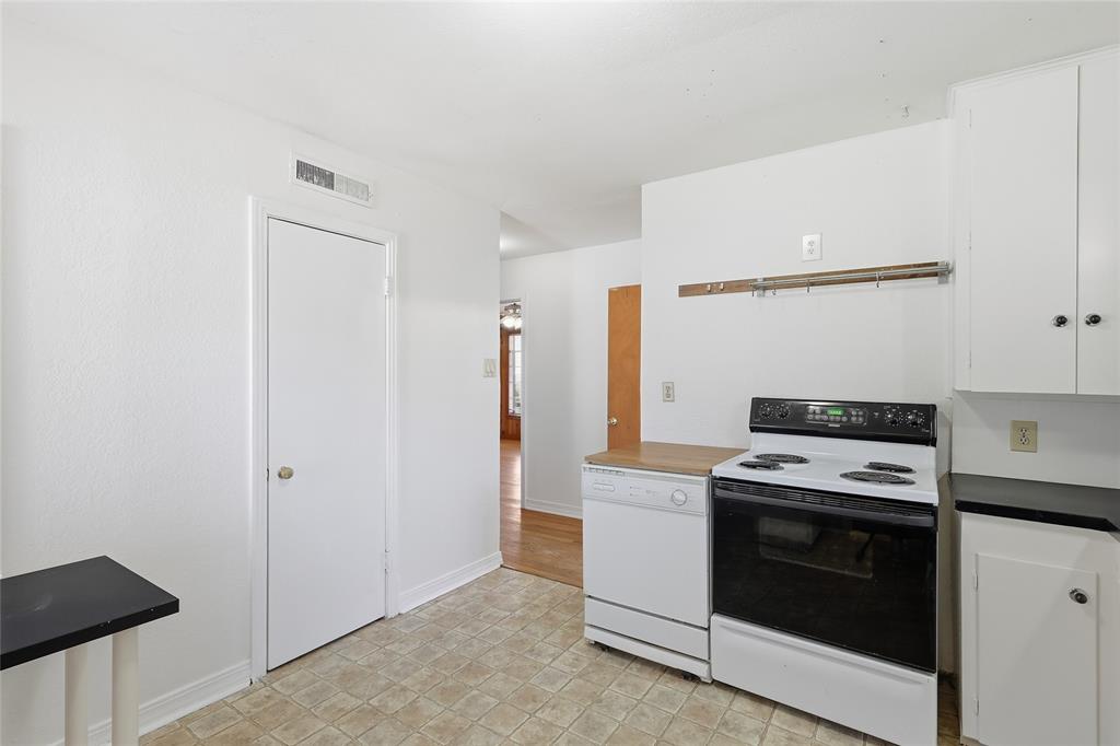 1822 West Hickory Street Denton, TX 76201 - Photo 12 of 20 a kitchen with a stove and a microwave