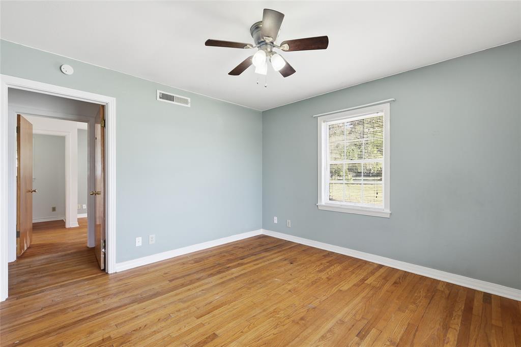 1822 West Hickory Street Denton, TX 76201 - Photo 14 of 20 wooden floor in an empty room with a window