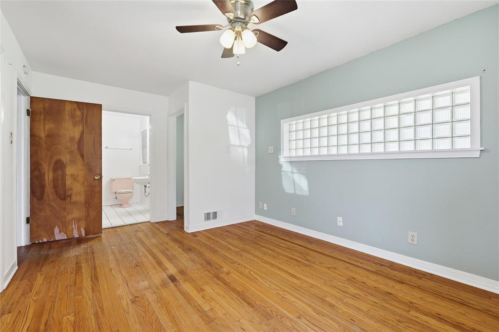1822 West Hickory Street Denton, TX 76201 - Photo 15 of 20 a view of an empty room with wooden floor and a window