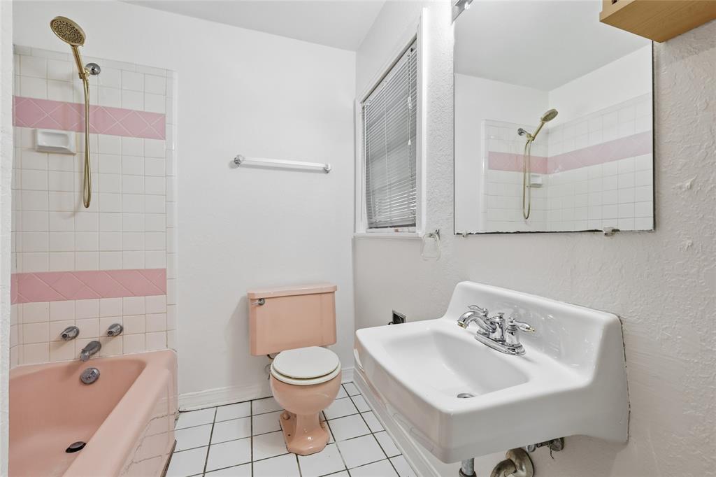 1822 West Hickory Street Denton, TX 76201 - Photo 19 of 20 a bathroom with a sink a toilet and shower
