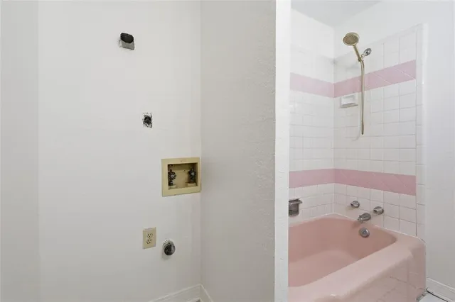 a bathroom with a bathtub and shower