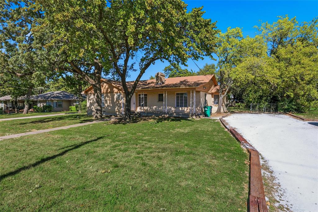 1822 West Hickory Street Denton, TX 76201 - Photo 2 of 20 a view of house in front of a big yard with large trees