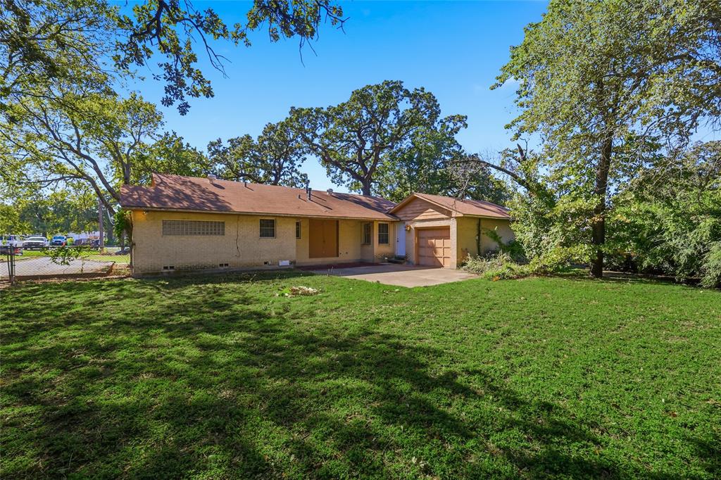 1822 West Hickory Street Denton, TX 76201 - Photo 3 of 20 a front view of a house with a garden