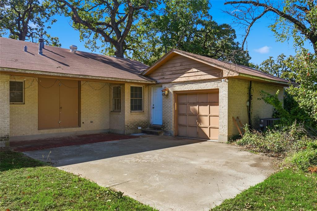 1822 West Hickory Street Denton, TX 76201 - Photo 5 of 20 a front view of a house with a yard and garage