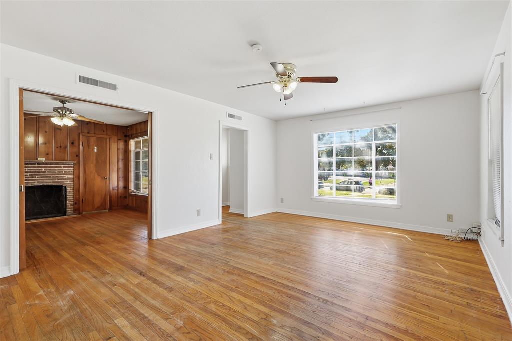 1822 West Hickory Street Denton, TX 76201 - Photo 7 of 20 a view of an empty room with wooden floor and a window