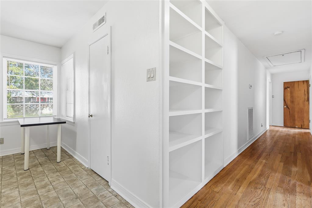 1822 West Hickory Street Denton, TX 76201 - Photo 10 of 20 a view of an empty room with wooden floor and a window
