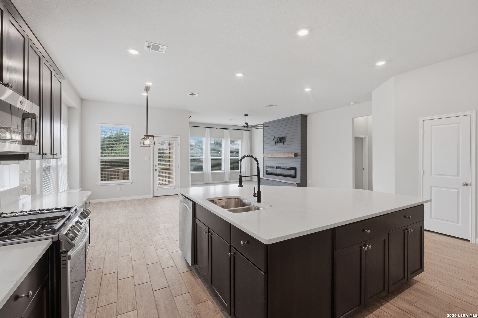 32125 Cardamom Way Bulverde, TX 78163 - Photo 12 of 32 a kitchen with a sink stove and cabinets