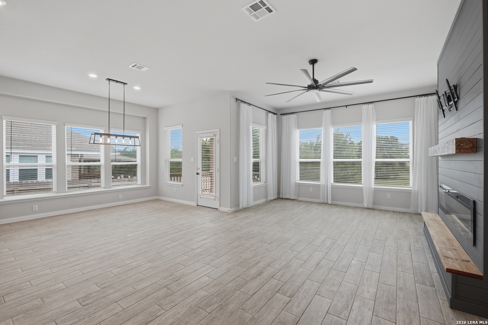 32125 Cardamom Way Bulverde, TX 78163 - Photo 13 of 32 a view of an empty room with a window and wooden floor